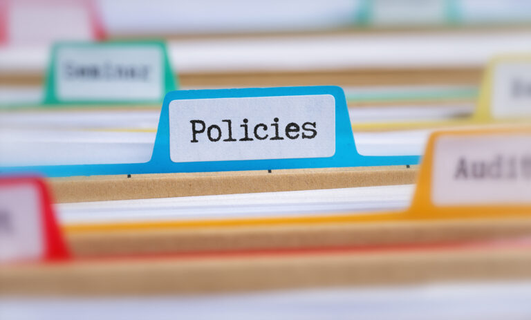 File folders with a tab labeled Policies.