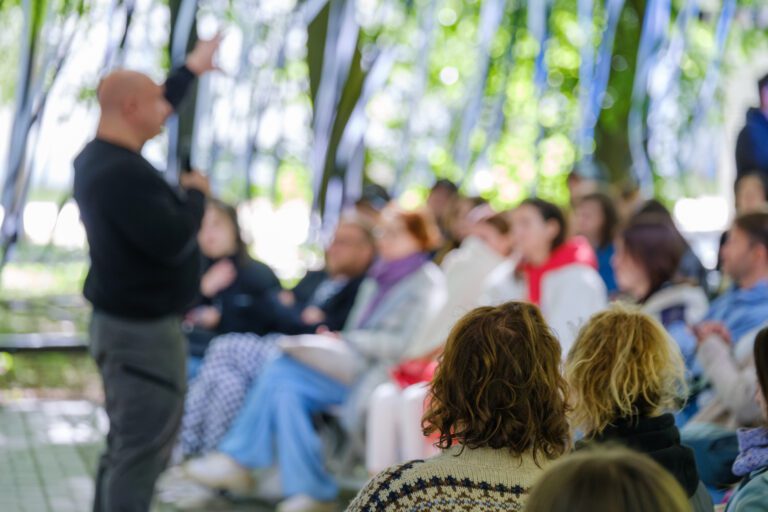 An outdoor workshop with a focused audience.
