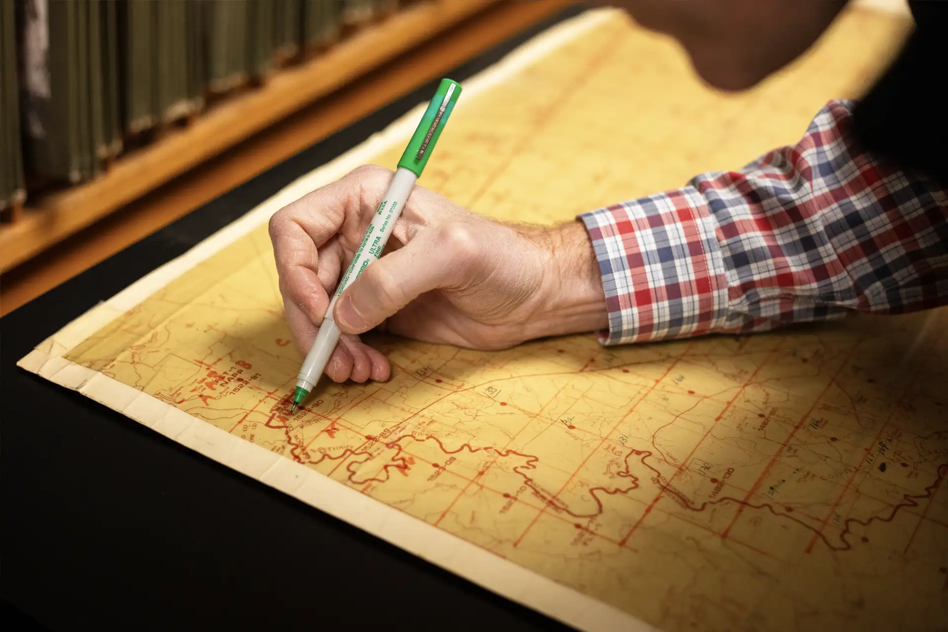 Someone making notes on a map.